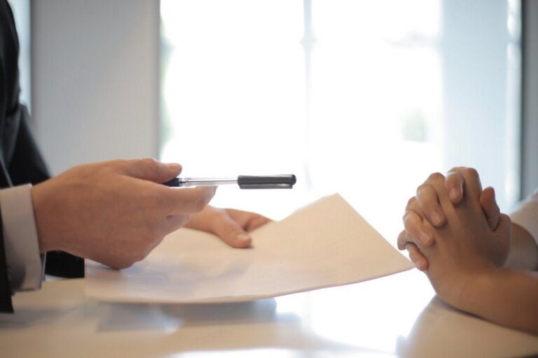 man-holding-a-pen-and-paper